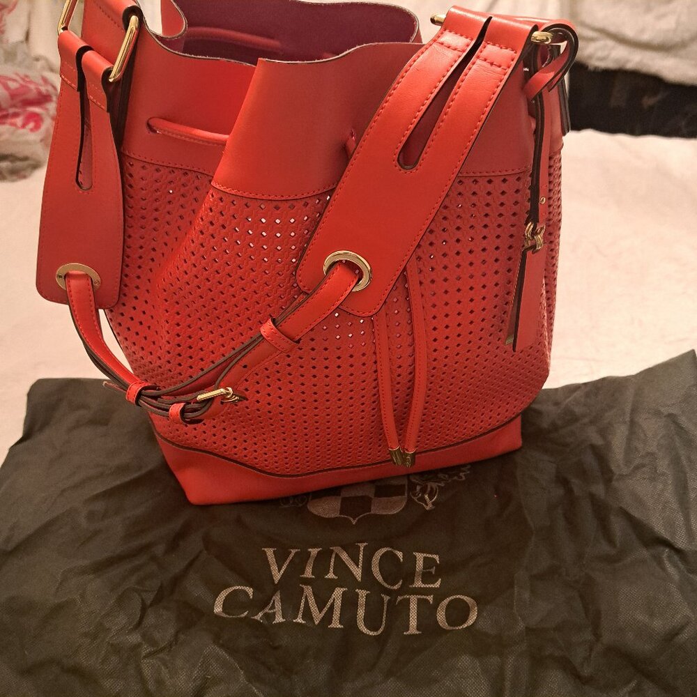 Vince Camuto orange perforated leather handbag with dustbag.  No call outs.